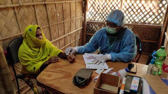 A medic assesses a patient at a camp in Cox’s Bazaar.