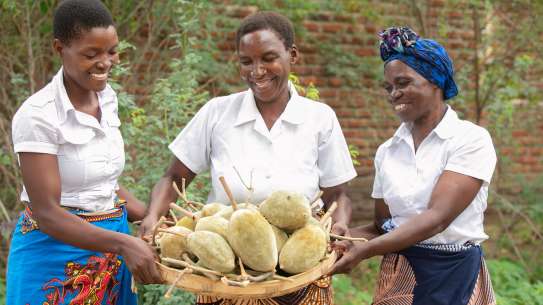 Makande Womens Group members holding baobab fruit