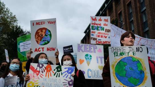 Young people hold placards at COP26 London climate march