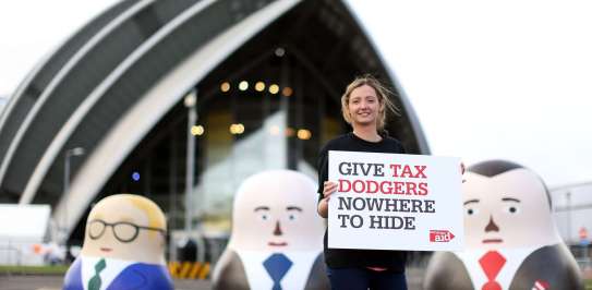 Tax campaigner standing next to some large russian dolls
