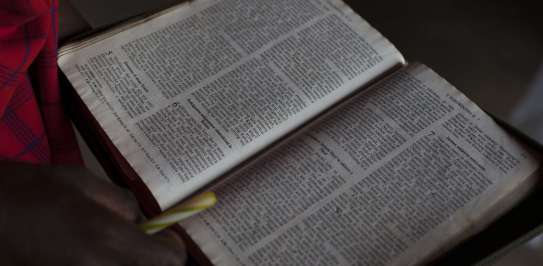 Open Bible held in hands