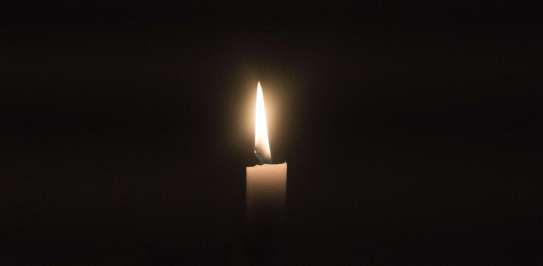 candle light shining in darkness