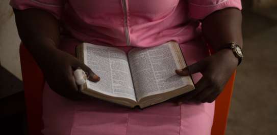 A women reading an open bible