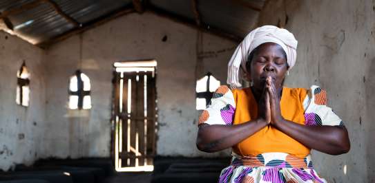 Lady eyes closed in prayer