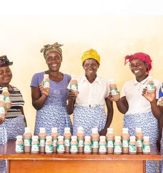 Eddina far left) and Janet (far right) with their Makande Womens Group and baobab juice