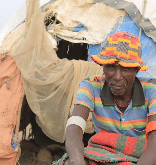 A man sitting outside of his makeshift tent in Ethiopia