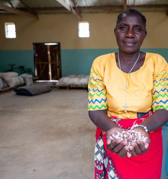 Woman holding crops in Malawi
