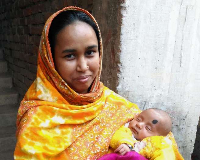 Amena Begum holding her baby