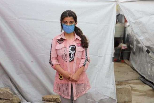 12-year-old Syrian refugee Yasmine outside her tented home in the Bekaa valley, Lebanon. 