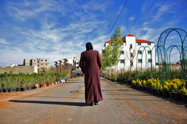 A woman walks down a road alone in lebanon