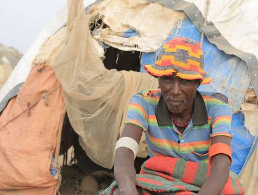 A man sitting outside of his makeshift tent in Ethiopia