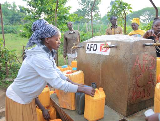 A woman in Ethiopia collecting water at a water point constructed by Christian Aid