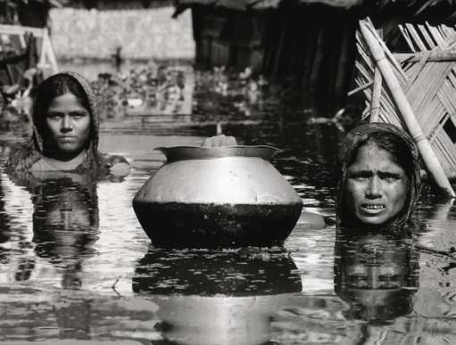 Mother and daughter in the flooded street outside their home in Dhaka, Bangladesh, September 1998