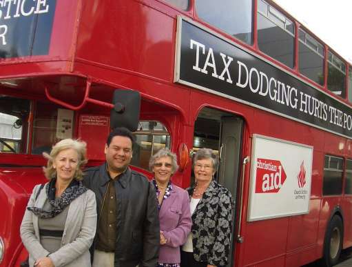 Jean Thompson and Deborah Doherty with 'tax dodging hurts the poor' bus in Bangor, NI.