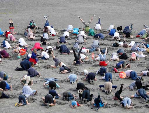 Climate change activists bury their heads in the sand at Sandymount Strand