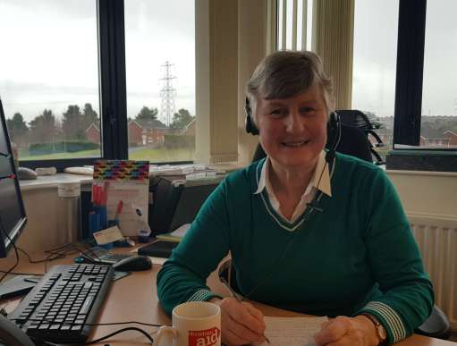 Suzanne Shepherd, a Christian Aid office volunteer Belfast, sits at desk