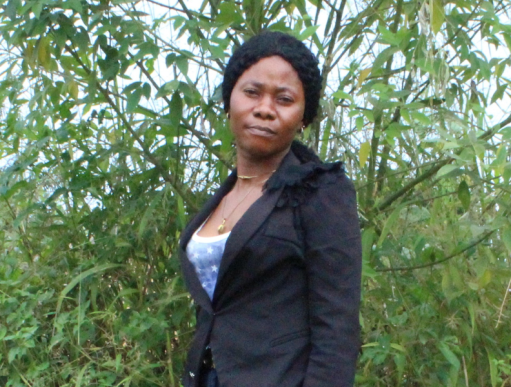 Woman standing in front of bushes in Sierra Leone