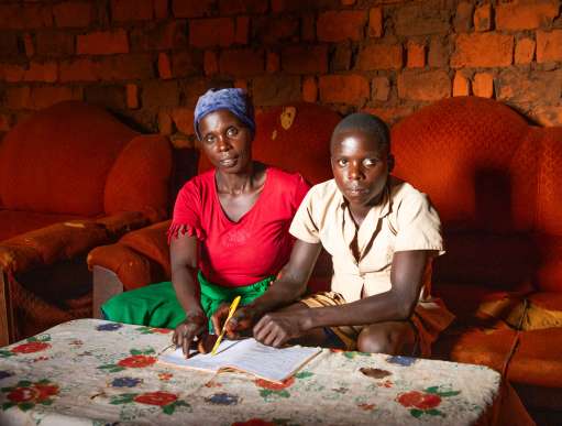 Mother and son sitting in home in Burundi