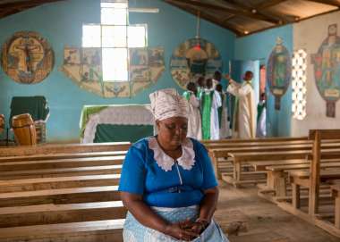 Florence Muthiani says a prayer inside her church.