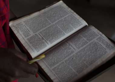 Open Bible held in hands
