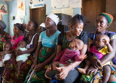 Mothers with their babies, sitting and waiting in a clinic run by Judith Lassie