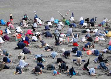 Climate change activists bury their heads in the sand at Sandymount Strand