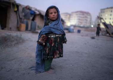 Child stands outside her home in a neighbourhood where many internally displaced people have been living for years, in Kabul, Afghanistan