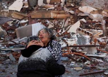 Women embracing after devastating earthquake