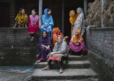 8 women gather in courtyard in Bangladesh